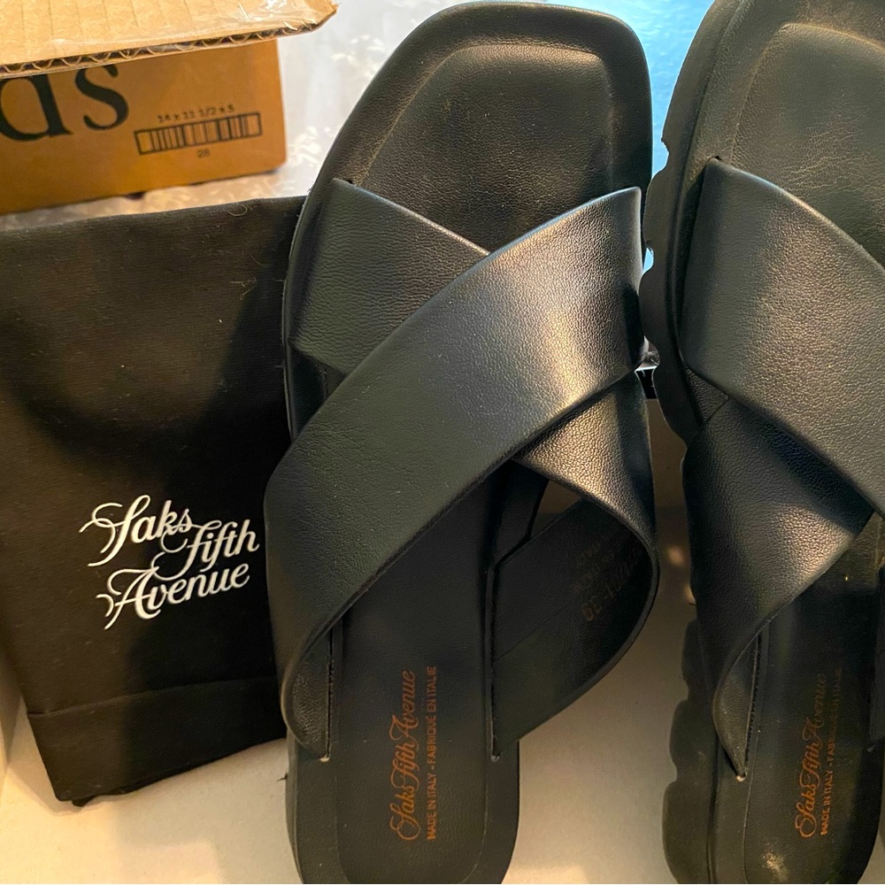 NEW Black slip on all Leather sandals from SAKS.  Comes with duster.